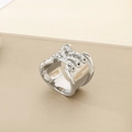 Macro shot of wide silver ring with knot design and sparkling rhinestone embellishments - 19mm Steel Color Cross Weave Style (KR111013-K)