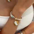 Baroque pearl bracelet with natural rose stone and blue glass beads on female wrist - Baroque Freshwater Pearl Bracelet