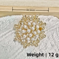 Golden eight-pointed star brooch with white pearls and rhinestones on white knit - KC Gold Gypsophila