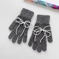 Close-up of grey knitted gloves featuring elegant white pearl bow decorations - M / Dark Grey (Gloves)