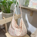 Floral canvas tote bag with vintage red flower prints on a rustic wooden chair - Striped Rose