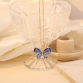Elegant gold butterfly necklace featuring a dark blue pendant on polished silk background - Sapphire Blue