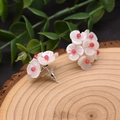 Elegant white floral stud earrings with pink center on a natural wooden background - Rose Red Shell Flower Style 10