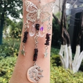Detail of arm-worn suncatcher with silver butterfly, crystal beads and celestial charms - Garnet