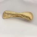 Elegant gold metal bow hair clip with brushed silk texture and spring clip closure - Gold Hammered Ribbed Bow Clip