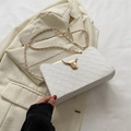 White woven leather crossbody bag featuring a golden clasp and elegant chain strap - White