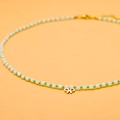 Close-up of green and white beaded necklace with a golden bow pendant and metal clasp - GX03098B (Bowknot Pendant)