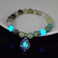 Luminous lotus flower charm on beaded stone bracelet glowing blue in the darkness - 8mm Natural Amazonite with Blue Light