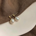 Macro detail of French vintage baroque pearl drop earrings with elegant gold metal finish - Style 9