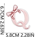 Detailed view of pink embroidered letter Q patch with red bow and 6.7x5.8cm dimensions - Bow Alphabet Letter Q