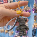 Grey crystal studded bear keychain with gold clasp and sparkling white strap handle - Gray