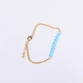 18K gold chain bracelet featuring seven sky blue crystal beads and lobster clasp - March - Aquamarine Blue