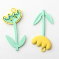 Close-up of colorful tulip flower charms with cute face designs for DIY jewelry - Yellow