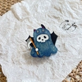 Close-up of Halloween blue glitter ghost brooch with skull mask and bat wings - Skeleton Ghost
