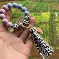 Detail of colorful silicone beaded bracelet with cow print leather tassel and metal clasp - Style 18-Purple Blue Cow Print/Cow Tassel