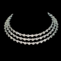 Elegant three-layer silver crystal necklace with sparkling round gemstones on black background - Choker Necklace / Silver