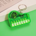 Mini green piano keychain musical toy with seven numeric buttons and a metal keyring - Bag Packaging / Transparent Green