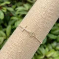 Detailed shot of 18k gold plated cross bracelet with Saint Jude medal and cubic zirconia - Zirconia Fine Chain Cross St. Benedict Medal (3)
