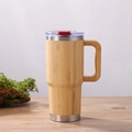 Insulated bamboo mug with stainless steel rim and handle on a natural wooden surface - 20oz Bamboo Shell Mug with Handle