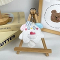 Cute white plush animal keychain with pink and blue ears on a mini wooden easel - Pocket Monster - White