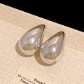 Macro shot of silver teardrop stud earrings with polished mirror finish on neutral surface - 17# Steel Needle Waterdrop Stud Earrings