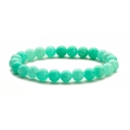 Macro shot of natural turquoise stone beads elastic bracelet with smooth texture - Green Jade
