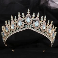 Golden Baroque bridal crown with blue rhinestones on black fabric background - KC Gold White Rhinestone + Green Opal
