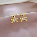 Macro detail of gold teddy bear earrings with heart-shaped zircon on silk fabric - Teddy Bear Heart Stud Earrings (D228)