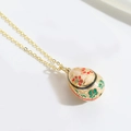 Detailed close-up of a vintage golden egg pendant with floral enamel painting - Pink (XL3225 Pink)