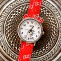 Close-up of a red cartoon cat quartz watch with a bow-shaped metal case for girls - Red