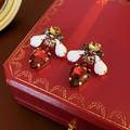 Vintage gold earrings with multi-colored gemstones on a luxury red velvet jewelry box - Silver Pin White Red