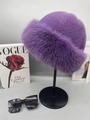 Chic violet faux fur winter bucket hat with plush texture on a display stand - Purple