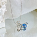 Silver titanium steel necklace with airplane and blue enamel globe pendant on a white base - Silver - Global Flight Necklace