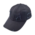 Detail shot of distressed black cotton baseball cap showing ripped vintage textures - Black