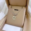 Close-up of silver Double Happiness pendant necklace in a luxury jewelry box - N231 Xi Character Round Plate Silver