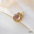 Detailed view of a gold moonstone pendant with a bow design on a pearl shell background - D294 Moonstone Auspicious Cloud