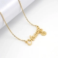 Macro detail of Aries letter pendant and zodiac charm on gold stainless steel chain - Aries
