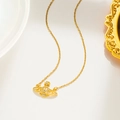 Macro detail of golden Saturn planet pendant with crystals and cross on necklace - Saturn Style (8823) / Gold