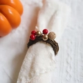 Handwoven rattan napkin ring with red beads and golden accents for table decor - Red Gold Bead Rattan Napkin Ring