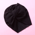 Detail view of black baby turban hat with large double-layer bow and pleated design - One Size / Black