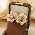 Exaggerated floral pearl earrings in white and gold finish displayed in a jewelry box - Enamel White Petal Flower Style (KE119653-SP)