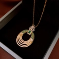 Detailed macro view of a pineapple pendant with green gemstones in a jewelry box - 10# Gold Necklace Pineapple Pendant