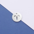 Detailed macro view of silver stainless steel circular Aries zodiac hollow pendant - Aries