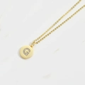 Minimalist gold necklace with a round G letter pendant featuring clear crystals - Letter G