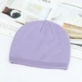 Soft light purple knitted beanie hat with ribbed cuff on a stylish magazine background - Purple