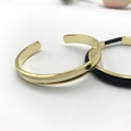 Polished gold curved open cuff bracelet with minimalist black cord jewelry for couples - Curved Gold