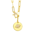 Close-up of gold paperclip chain necklace with pave-set heart lock and saturn pendant - Planet
