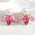 Detail of luxury gold earrings featuring a white pearl and clustered pink crystals - Rose Pink