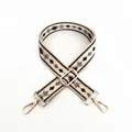 Detailed view of beige bag strap with green geometric patterns and gold metal hooks - A4 Pattern - Silver Buckle