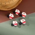 Dettaglio di cinque graziose mollette per capelli a forma di Babbo Natale per le feste - Set di 5 Fermagli per Capelli Babbo Natale
